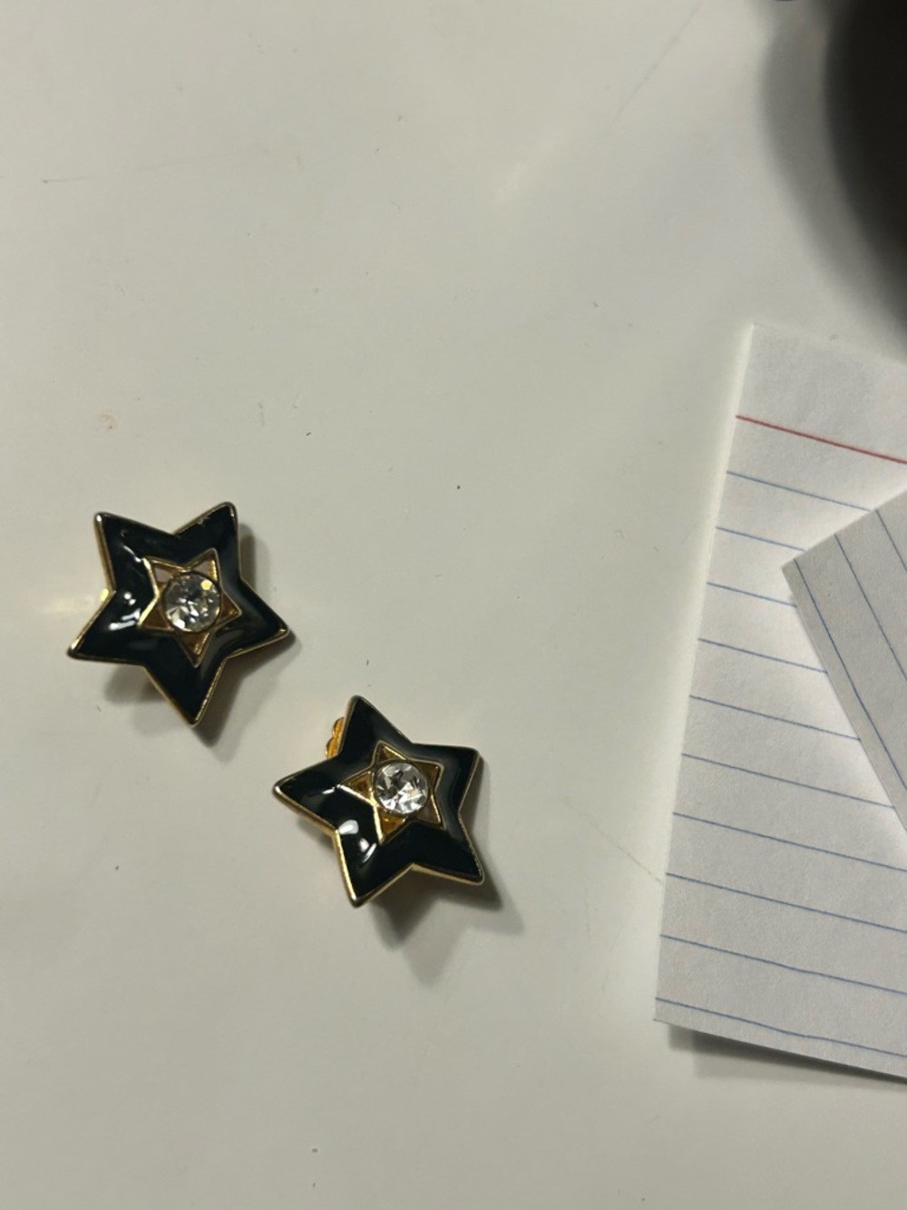 Gold-Trim Black Star Clip Earrings with Clear Crystal Centers